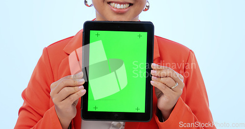 Image of Woman, hands and tablet with green screen in studio by blue background. Female model, tracking markers and chroma key on digital device, technology and display or promotion, online and mock up