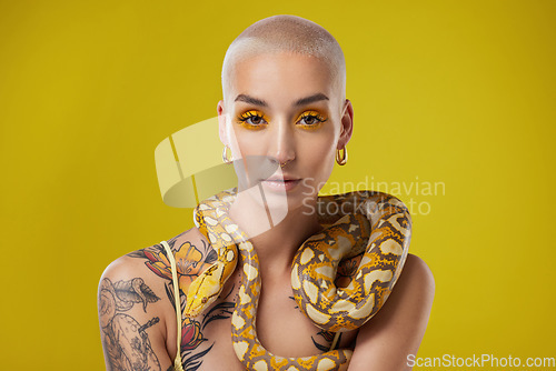 Image of Exist loudly. a young woman posing with a snake around her neck against a yellow background.