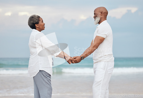 Image of Happily in too deep. a mature couple spending time at the beach.