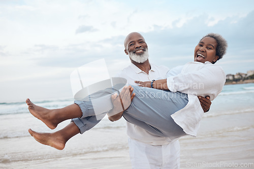 Image of Be careful, dont trip on your cape. a mature couple spending time at the beach.