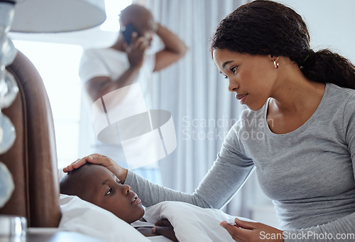 Image of Hope hell be okay. a woman taking her little boys temperature with a thermometer in bed at home.