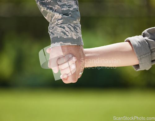 Image of In time of test, family is best. a unrecognizable man holding his sons hand outside.