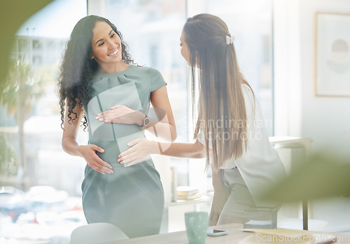 Image of Thank you for supporting my at work through my pregnancy. a businesswoman touching her colleagues pregnant belly in an office.