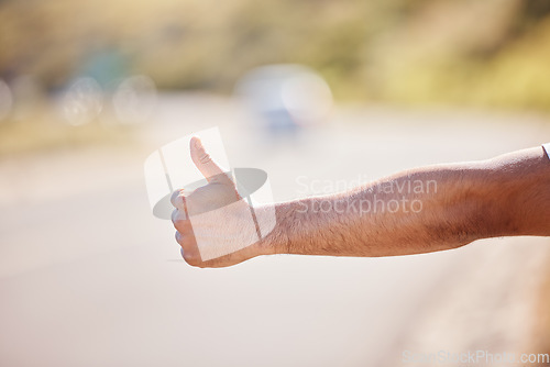 Image of Anyone care to help. Closeup shot of an unrecognisable man showing thumbs up outdoors.