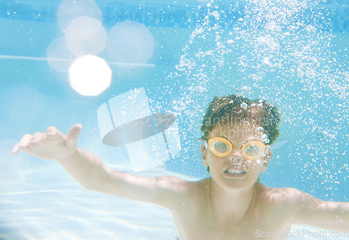 Image of But it is not just fun, swimming also provides loads of health benefits. a little boy wearing swimming goggles while swimming underwater.