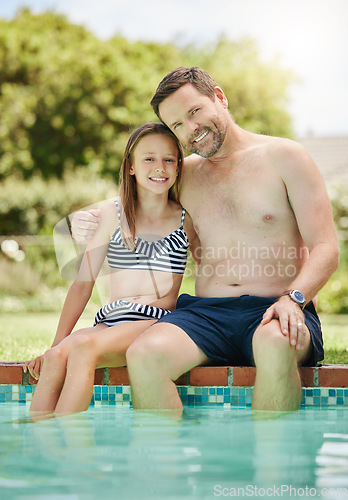 Image of She loves swimming as much as I do. a man and his daughter bonding by the poolside.