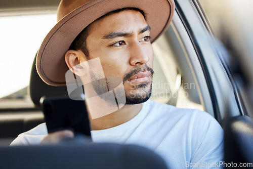 Image of Good company in a journey makes the way seem shorter. a young man sitting in a car while using his phone.