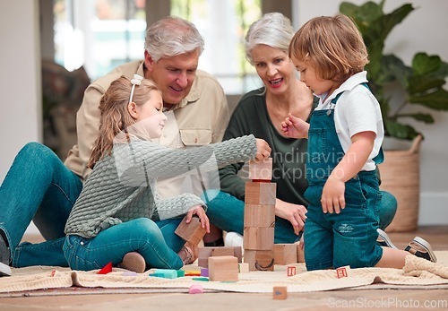Image of Cant reach up too high. a mature couple bonding with their grandkids at home.