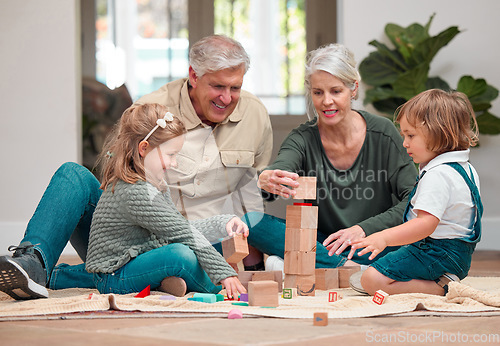 Image of Love lives in these building blocks. a mature couple bonding with their grandkids at home.