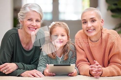 Image of Little girls rule the world. Portrait of a mature woman bonding with her daughter and granddaughter while using a digital tablet.