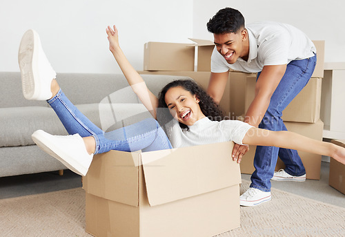 Image of We love being silly together. a young couple moving into their new house.