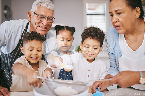 Image of This is going to be extra sweet. a mature couple baking with their grandkids at home.