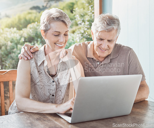 Image of Im curious to see what you want to show me. a mature couple using a laptop while sitting outside.