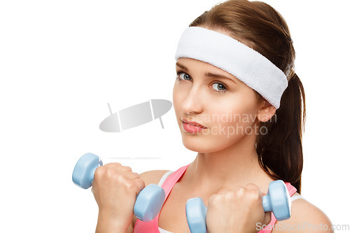 Image of Determined to build these biceps. a young woman using weights against a studio background.