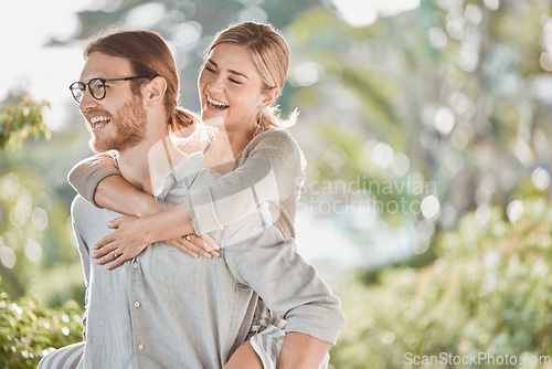 Image of We can be playful together. a young couple spending time together in the garden at home.