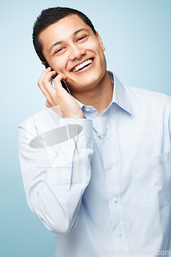 Image of Never leave without my phone. a young businessman making a phone call against a studio background.