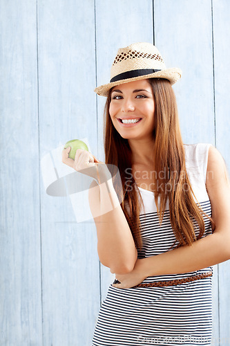 Image of Its never too early for a healthy snack. a young woman about to eat an apple.