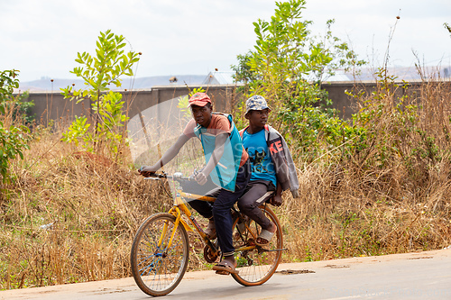 Image of Two Malagasy men on one bike. Mandoto, Madagascar