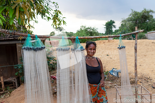 Image of Malagasy woman selling fishing nets. Miandrivazo, Madagascar