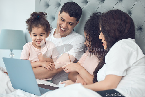 Image of Treasured family time. a beautiful young family talking and bonding in bed together.