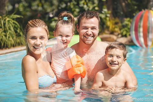 Image of Family time in the pool. Cropped portrait of a young family of four swimming outside.