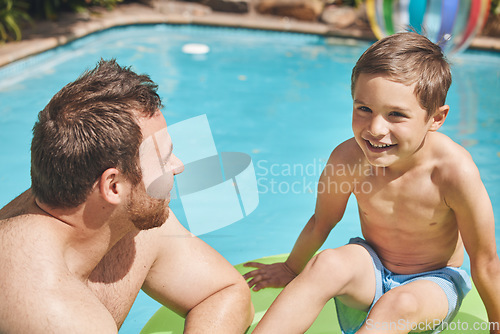 Image of What do you wanna do today. High angle shot of a handsome young man and his son swimming outside.
