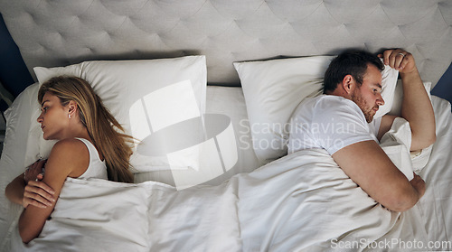 Image of I dont think I want this anymore. a young couple give each other the silent treatment in bed.