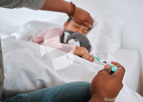 Image of Whats her temperature. an unrecognizable parent checking a sick boys temperature at home.