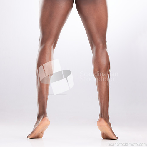 Image of Toned legs are underrated. an unrecognizable man showing off his muscular legs while posing against a white background.