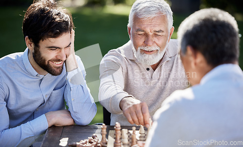 Image of Ill teach you the ways of the world of chess. a group of men playing a game of chess outside.