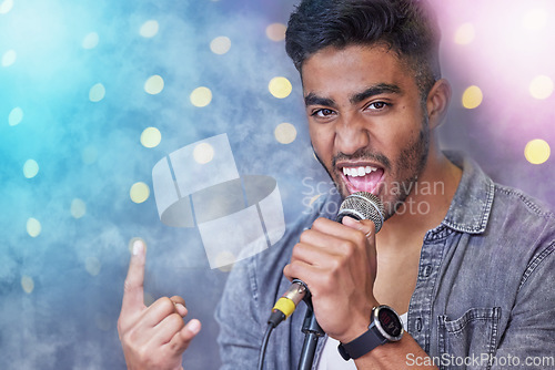 Image of Hes so rock n roll. Cropped portrait of a handsome young male rocker singing on stage.