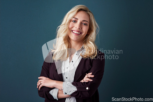 Image of Confidence, determination and persistence is whats needed in business. Studio shot of a beautiful young businesswoman posing against a blue background.