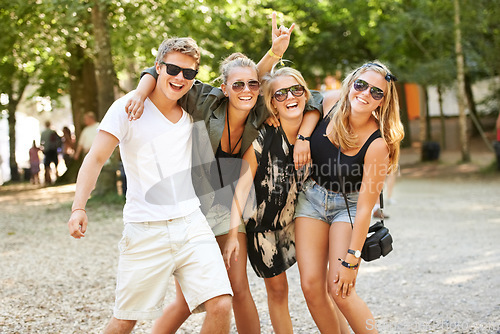 Image of Living the festival life. Four friends partying and celebrating at a music festival.