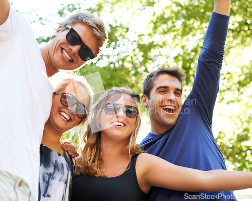 Image of Rocking out together. Four friends partying and celebrating at a music festival.