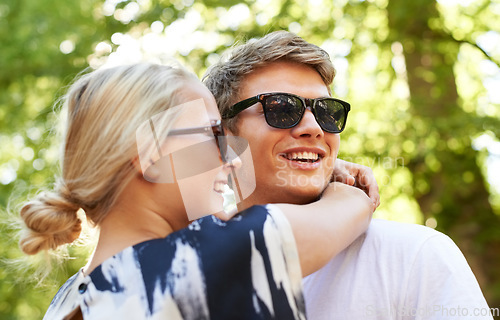 Image of Festival romance. A young couple embracing at an outdoors music festival.