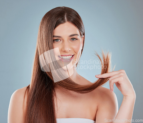 Image of When our hair feels good you cant help but to feel good. Studio shot of a beautiful young woman showing off her long brown hair.