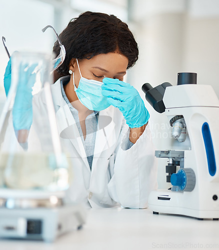 Image of This case is proving very hard to solve. a young scientist looking stressed out while working in a lab.