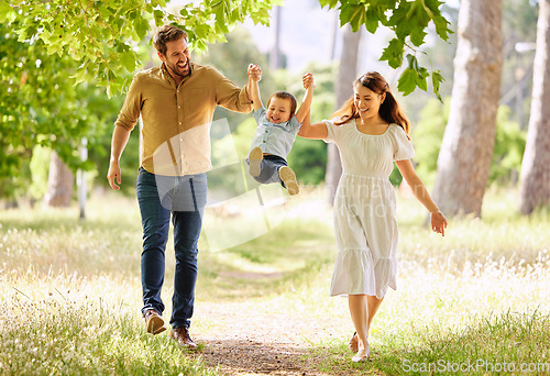 Image of When hes happy, were happy. a family taking a walk in the park.