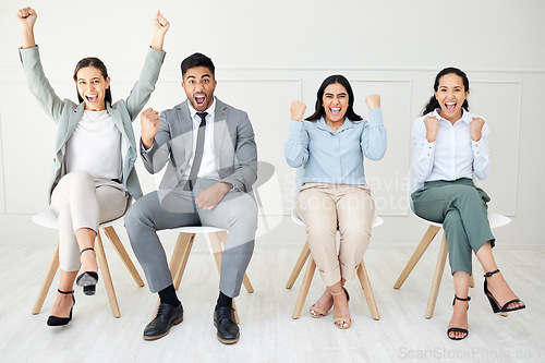 Image of All vying for the same position. Portrait of a group of businesspeople people cheering while sitting down against a grey background.