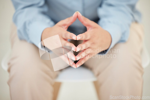 Image of Its been weighing on his mind. Closeup shot of an unrecognizables hands while sitting nervously in the studio.