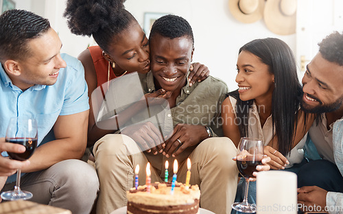 Image of May all your wishes come true. a young man celebrating his birthday with friends at home.