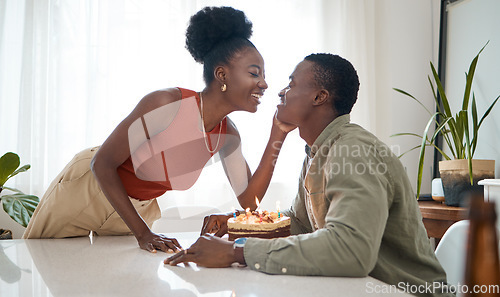 Image of Make a wish. a young woman celebrating her boyfriends birthday with him at home.