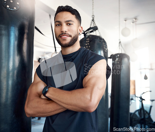 Image of A healthy and happy body is worth the effort. Portrait of a sporty young woman standing with his arms crossed in a gym.