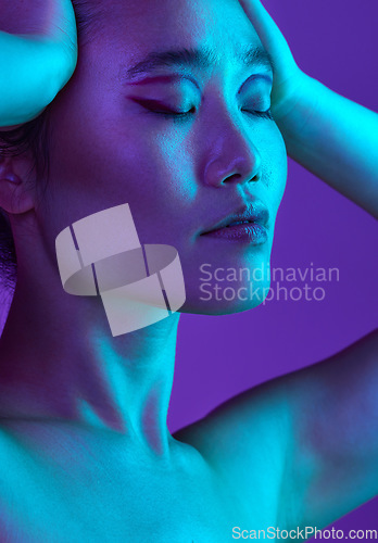 Image of Bought a brand new attitude. an attractive young woman posing in studio against a purple background.