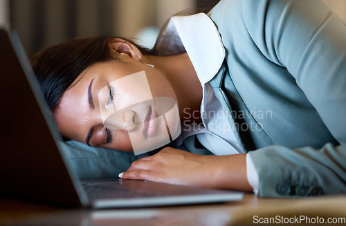 Image of Some days are longer than others. an attractive young businesswoman sleeping on her desk while working late at the company offices.