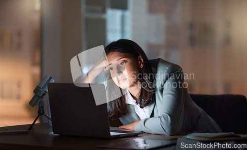 Image of These late nights are a little too much. an attractive young businesswoman looking bored while working late at her company offices.