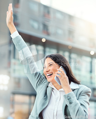 Image of And then one day, success came her way. a young businesswoman using a smartphone and gesturing to order a cab against an urban background.