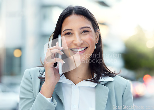 Image of Love it, lets talk more. a young businesswoman using a smartphone against an urban background.