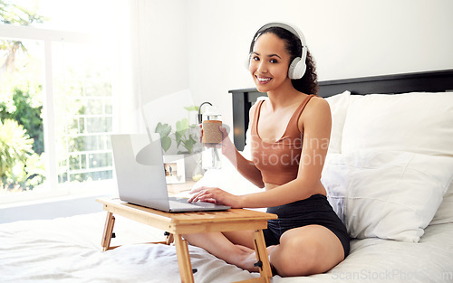 Image of Today is a chance to create the life you want. a young woman using a laptop while sitting on her bed at home.