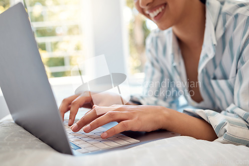 Image of Inspiration finally hit me. an unrecognizable person using a laptop while relaxing on her bed at home.